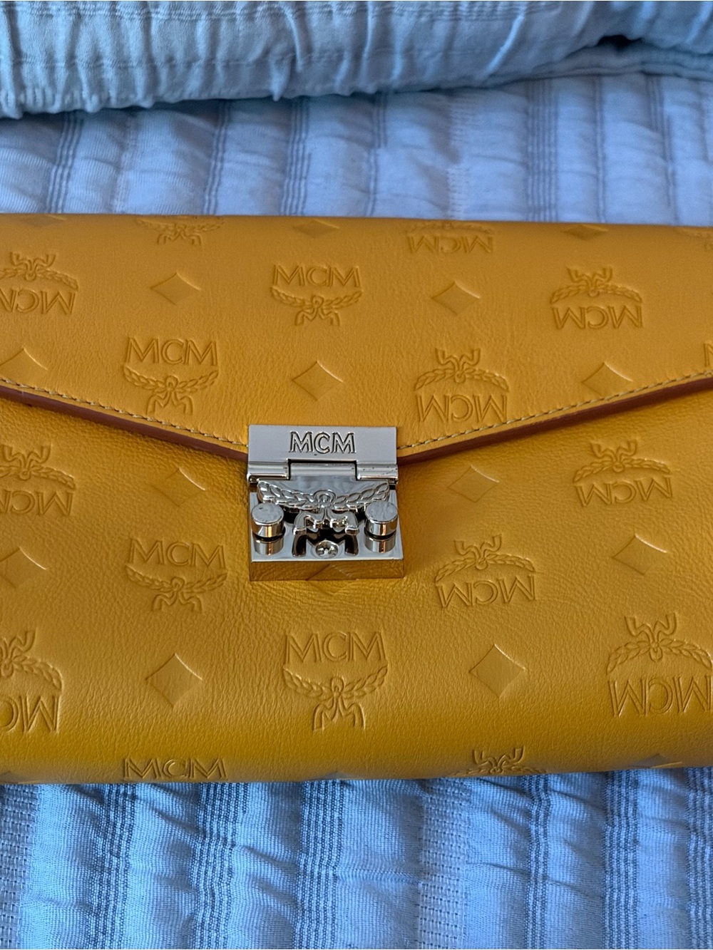 MCM Embossed Leather Envelope Clutch in Mustard